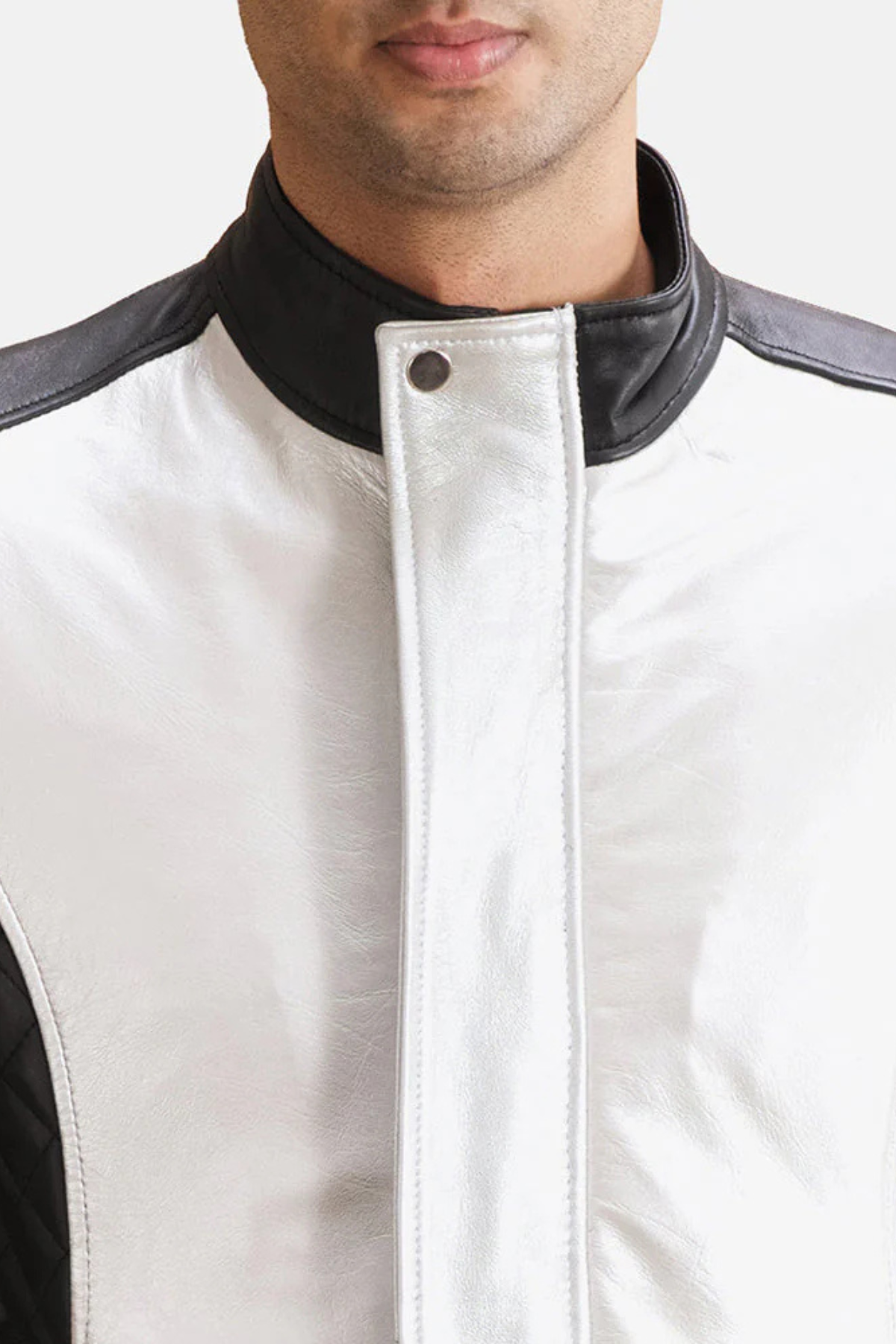 Close-up of a white leather vest with black accents