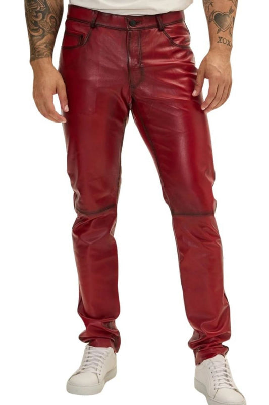 Red leather pants worn by a person on a white background