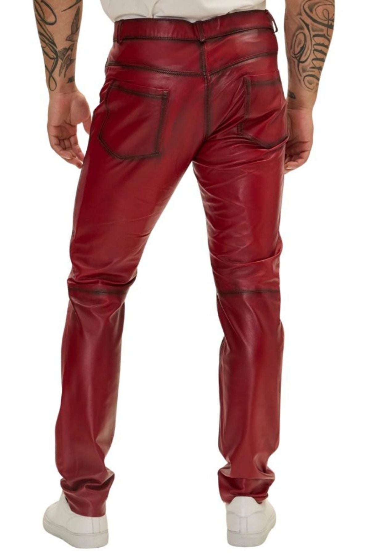 Red leather pants worn by a person on a white background