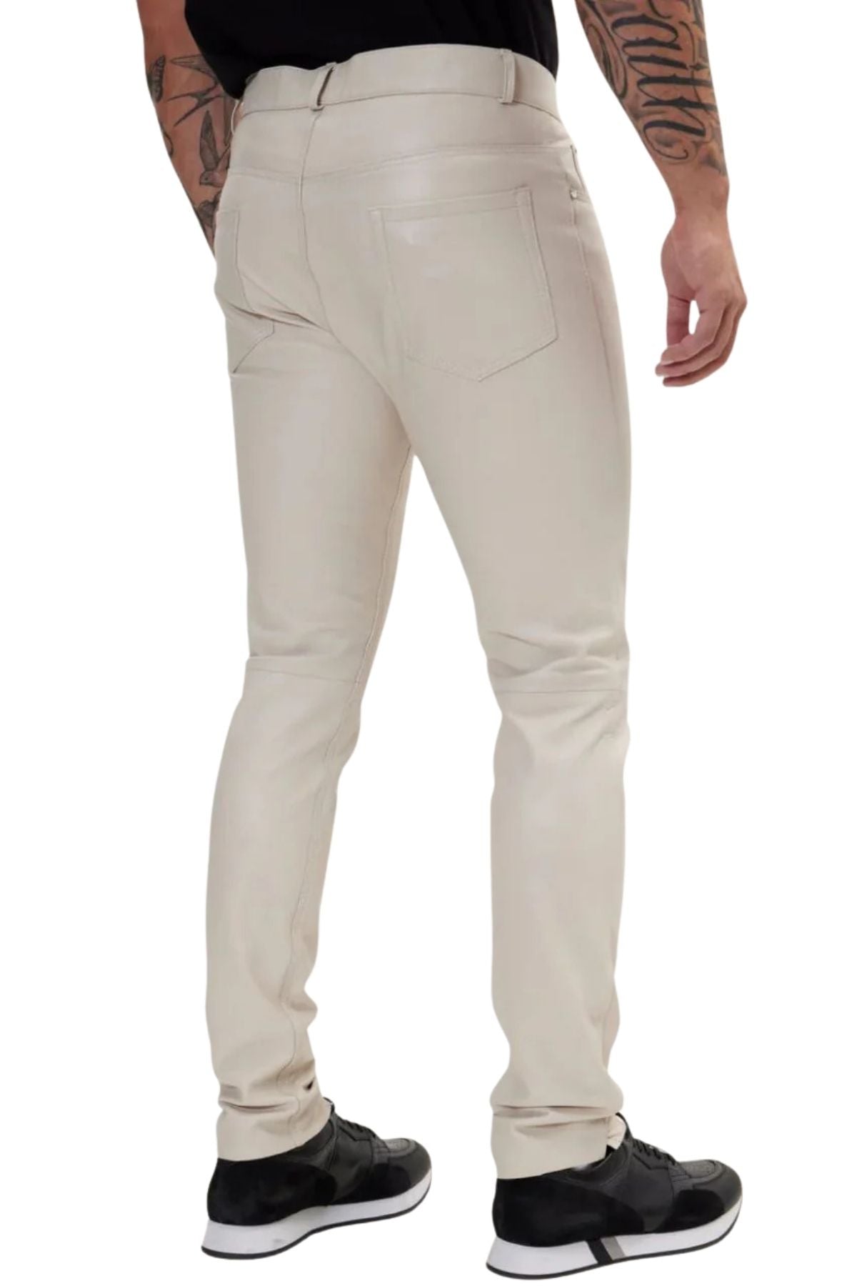 Beige pants worn by a person on a white background