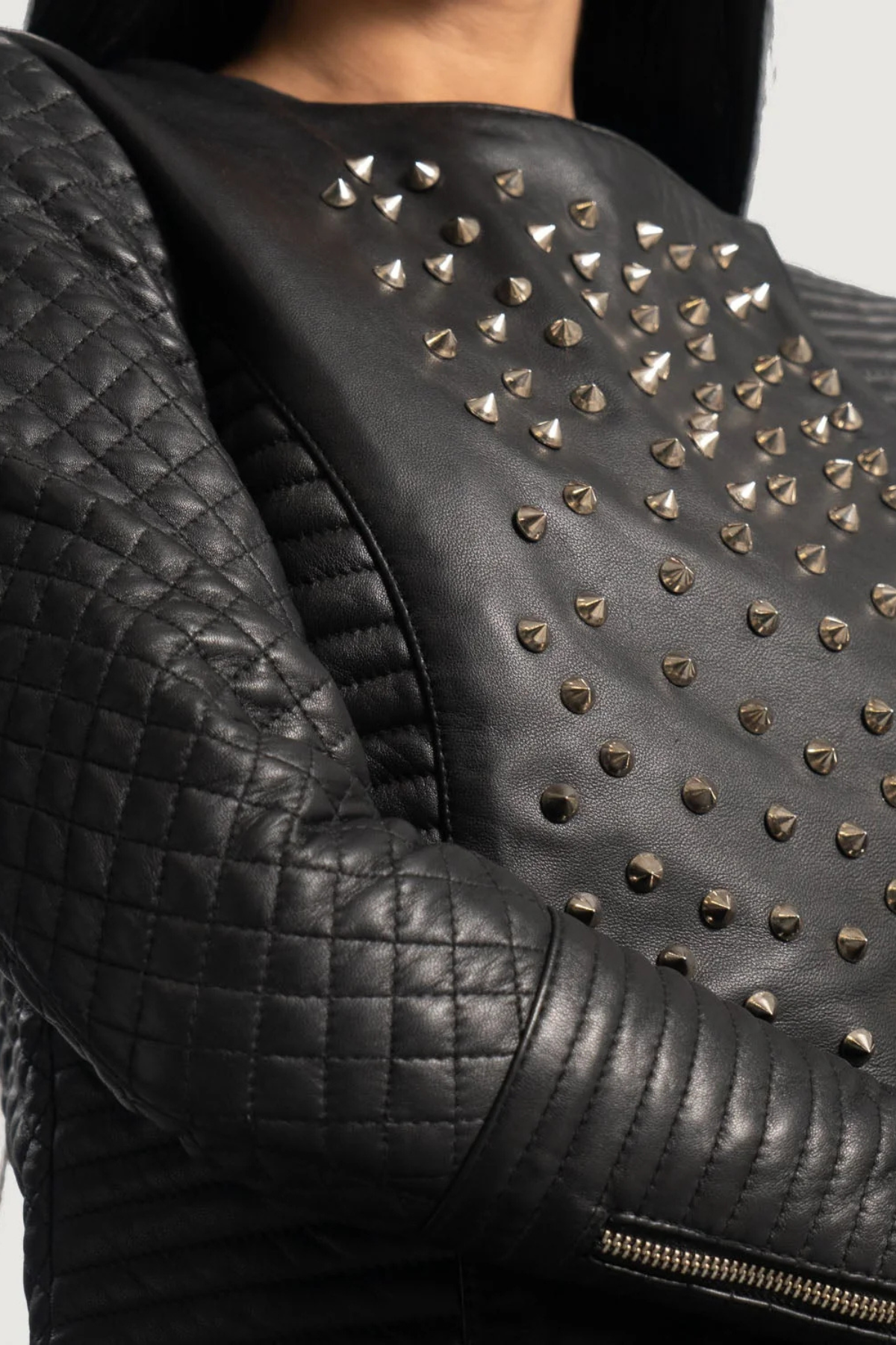 Black leather jacket with studs on a neutral 