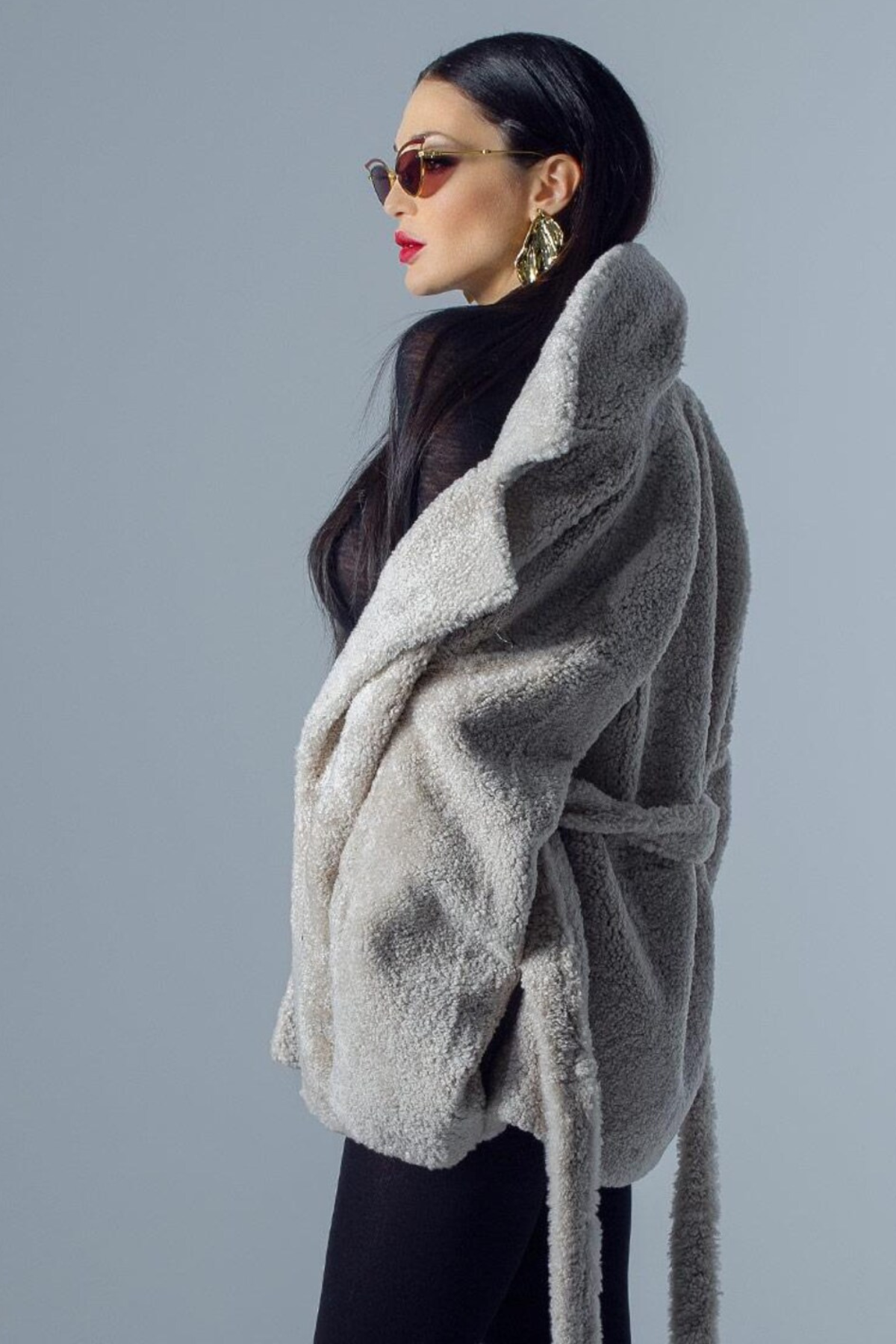Woman wearing a gray fluffy cardigan 