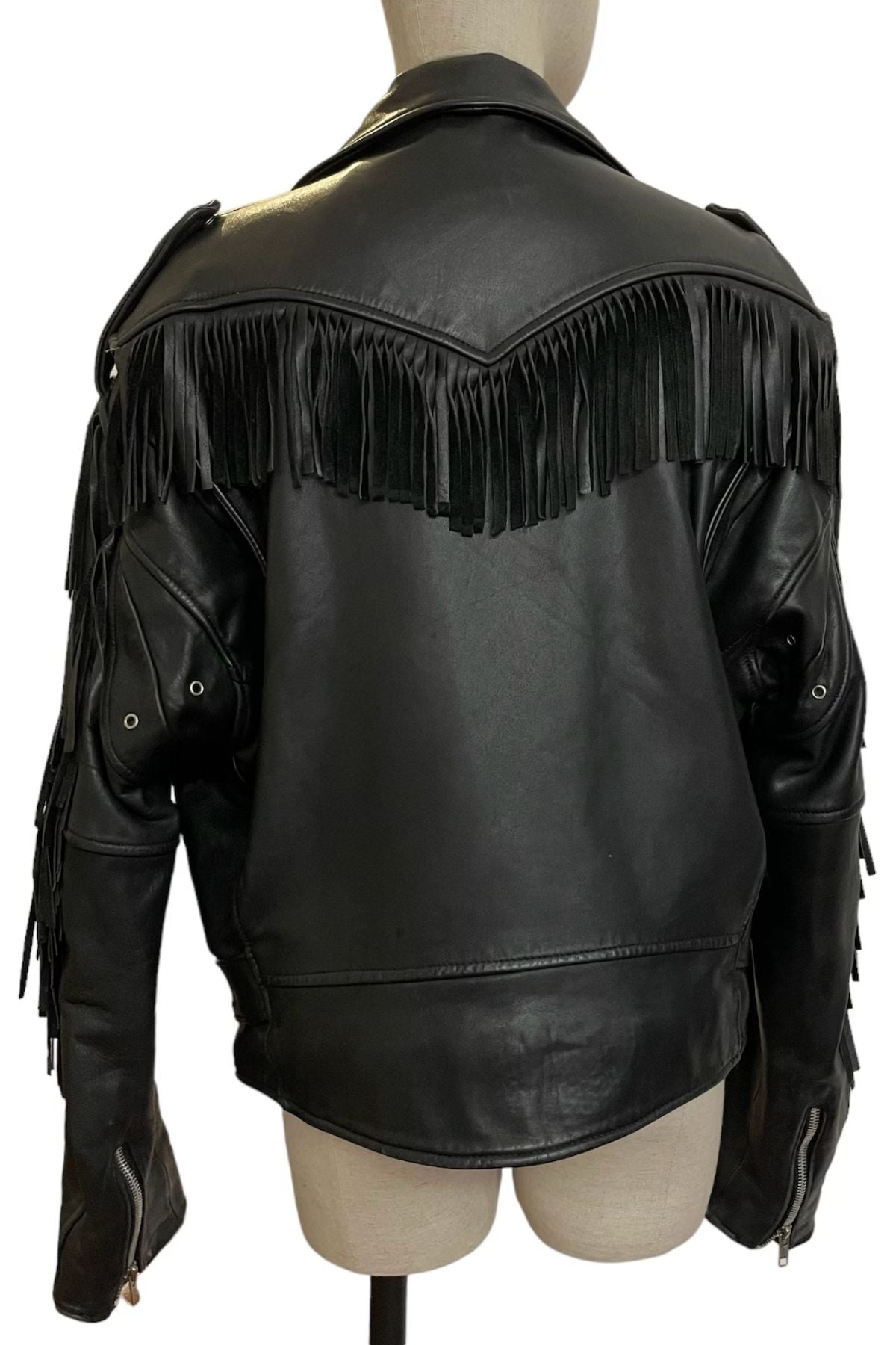Black leather jacket with fringe details on a mannequin 