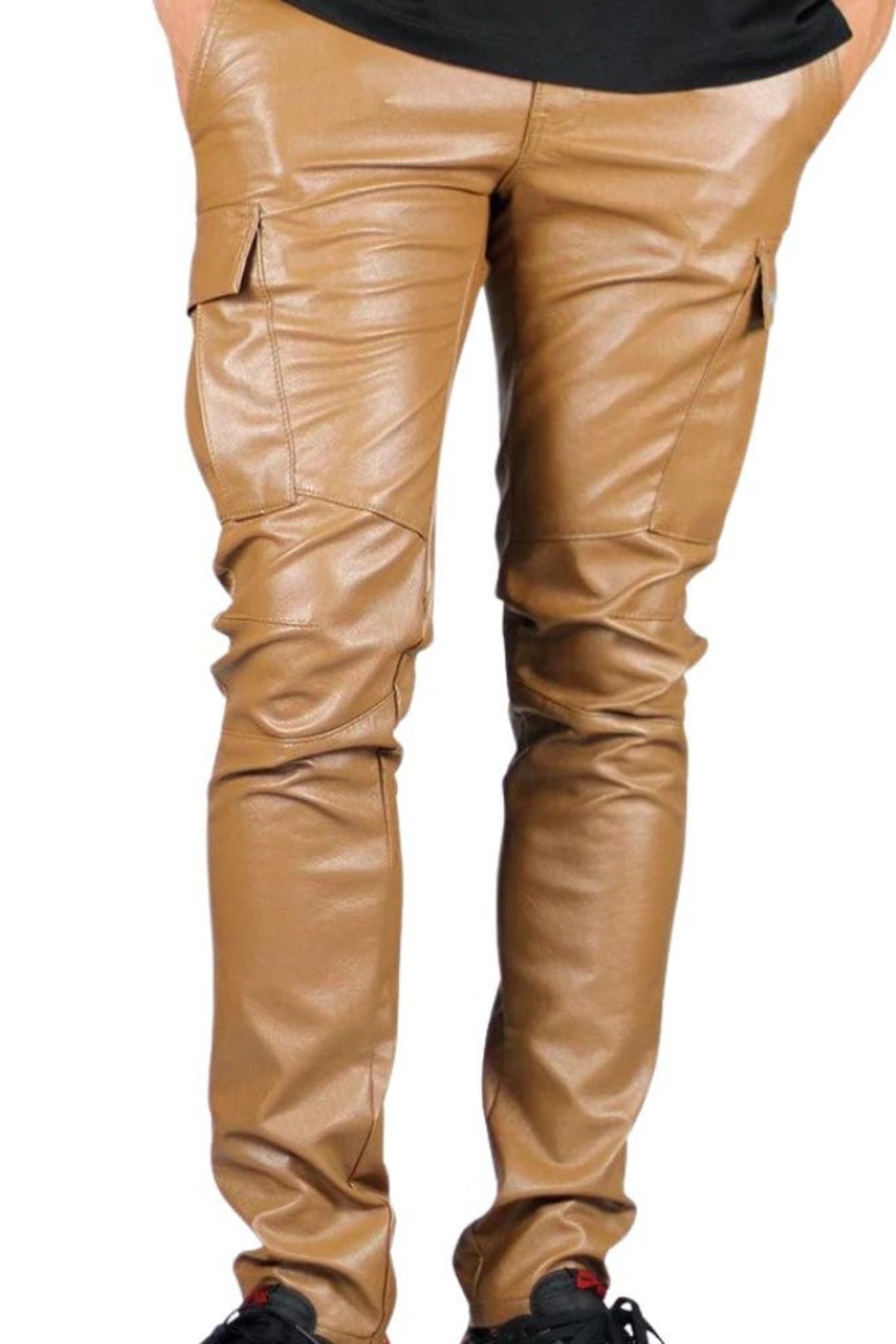 Tan leather pants worn by a person on a white background
