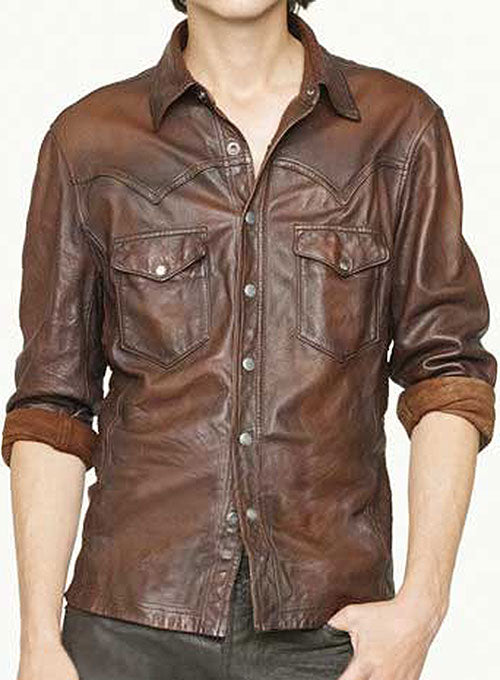 "Front view of a man wearing a vintage brown leather Western shirt with snap buttons and two pockets"